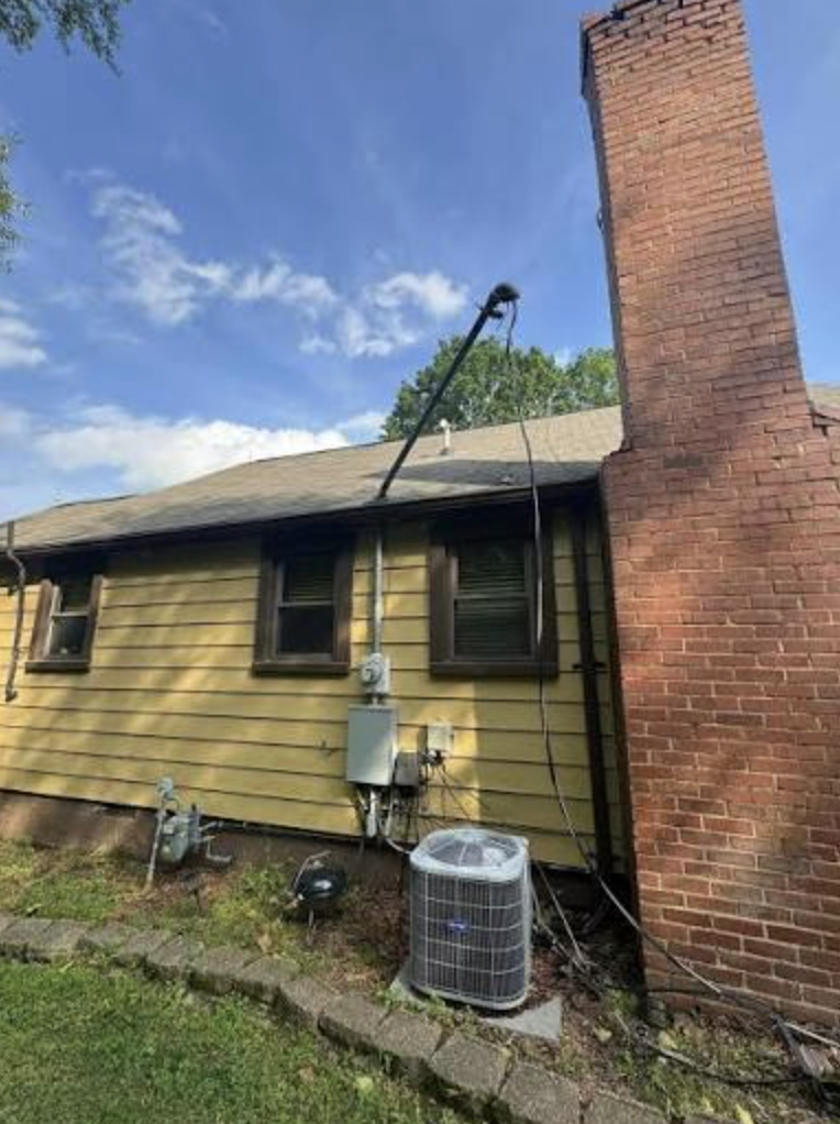 Storm-damaged electrical service mast repair on a rural Readington NJ home